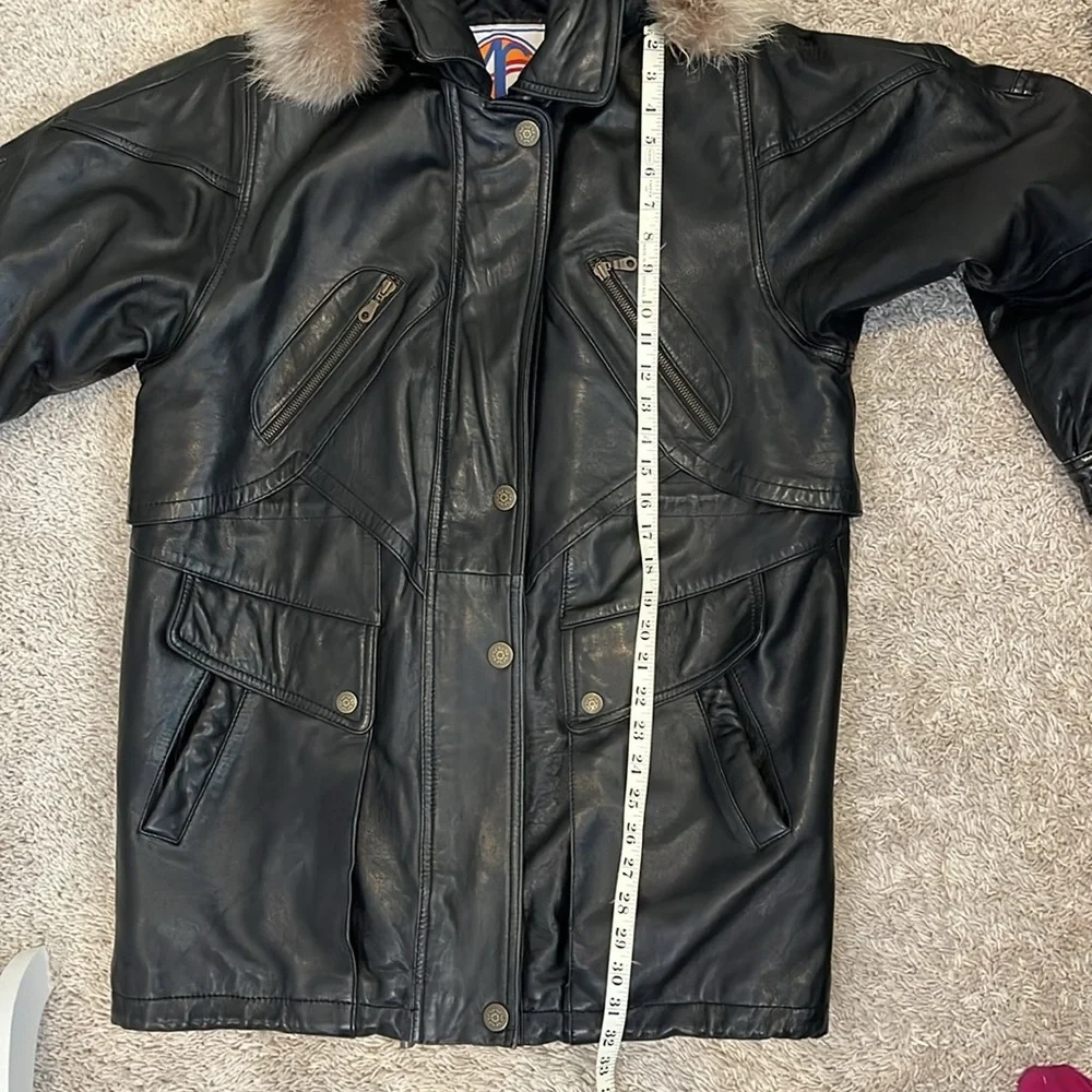 Vintage men’s SZ sm black leather coat w/fur trim hood.  Hits below the hips.